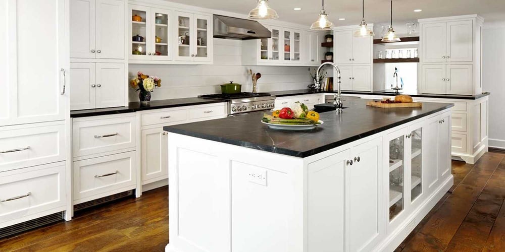 Image of a kitchen in a custom home with a large central island and custom cabinets by TR Design Build