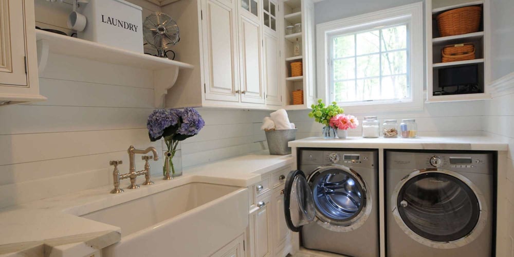 Image of a remodeled laundry room with custom cabinetry and deep sink by TR Design Build in New Canaan, CT