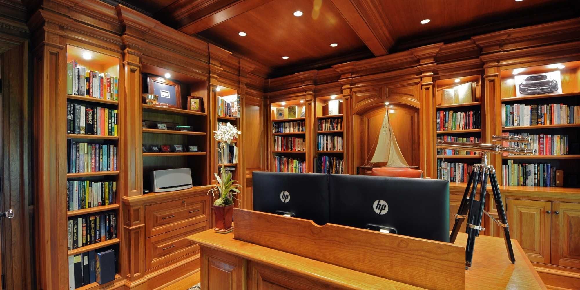 Custom home office with library and display shelves in a New Canaan custom home by TR Design-Build