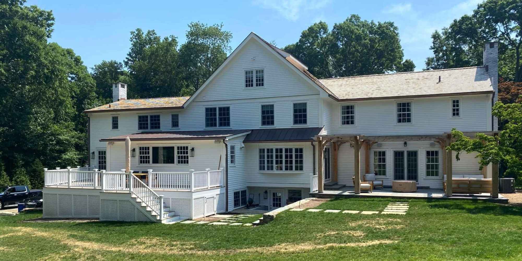 Large custom home with a large back yard and multiple outdoor living areas in New Canaan by TR Design-Build