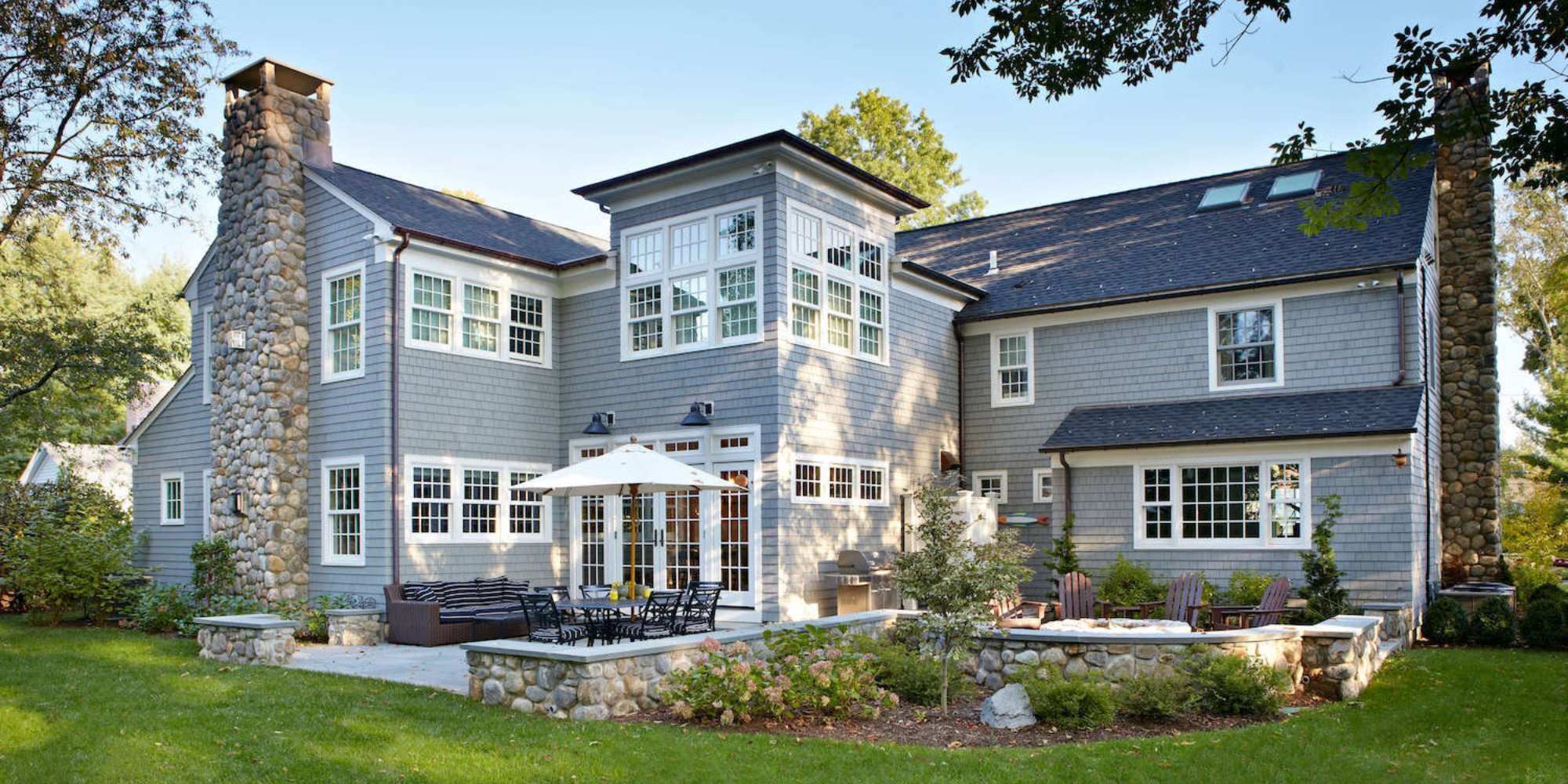 Exterior of a large home addition with a patio by TR Design-Build