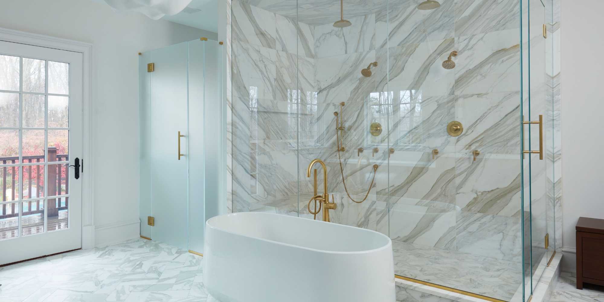 Custom home bathroom in New Canaan, CT by TR Design Build with luxury shower, soaking tub, and gold fixtures
