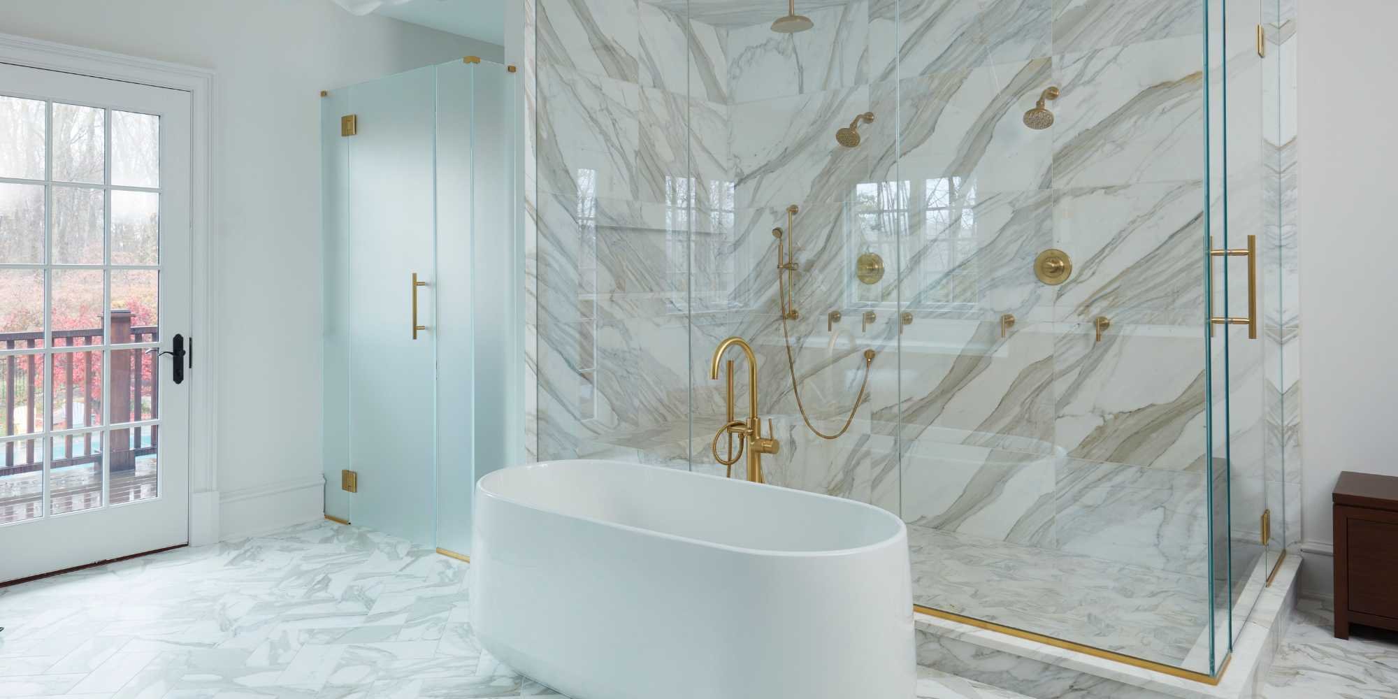 Standing shower and soaking tub with gold accents in a custom bathroom in New Canaan, CT