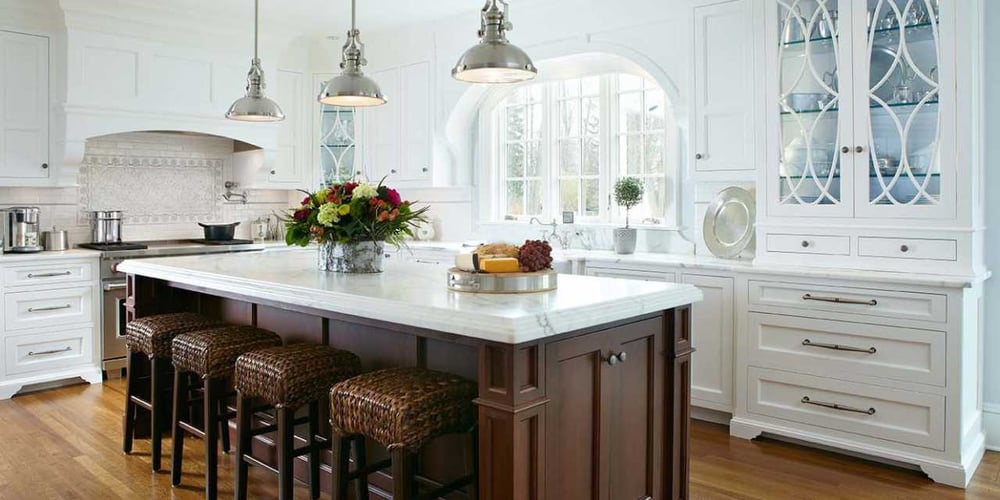Spacious and bright remodeled kitchen with a large wooden island by TR Design Build in New Canaan, CT