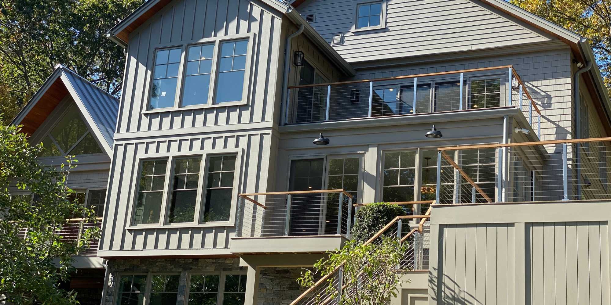 TR Design Build custom home in New Canaan featuring large windows and multi-level decks