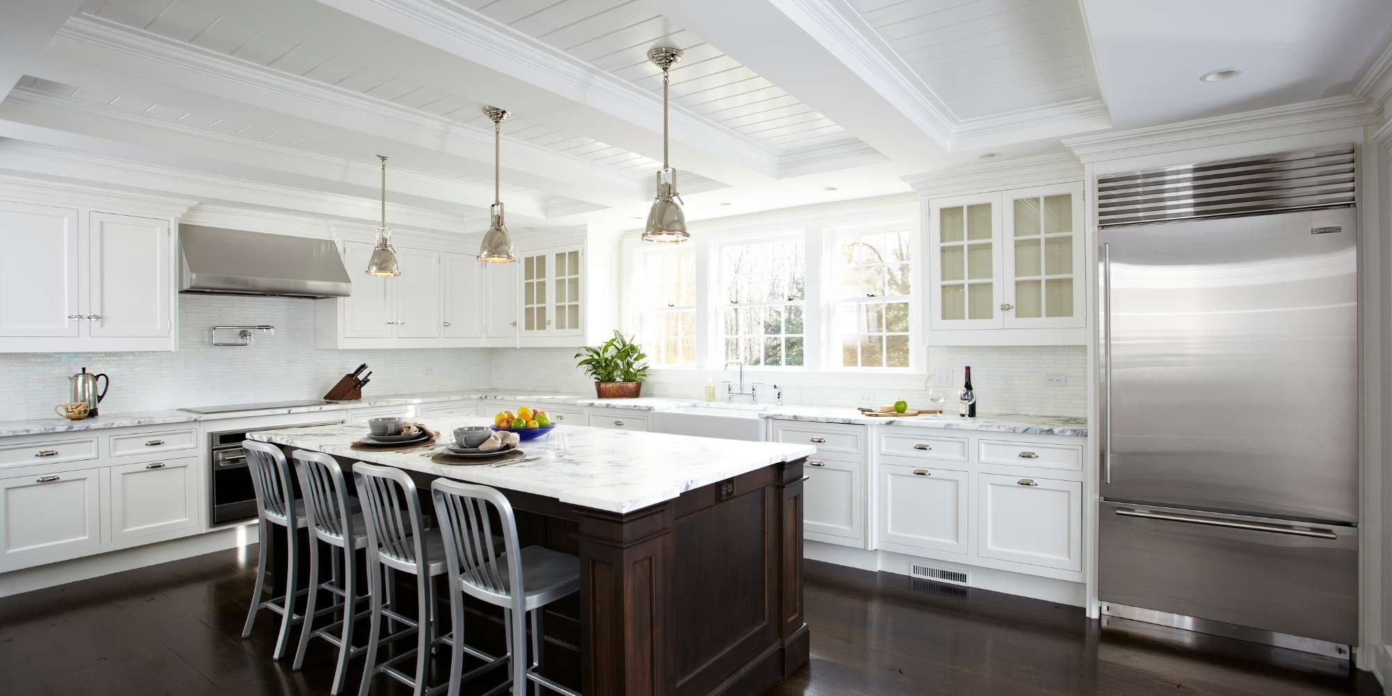 Bright kitchen addition with marble island by TR Design Build in New Canaan, CT