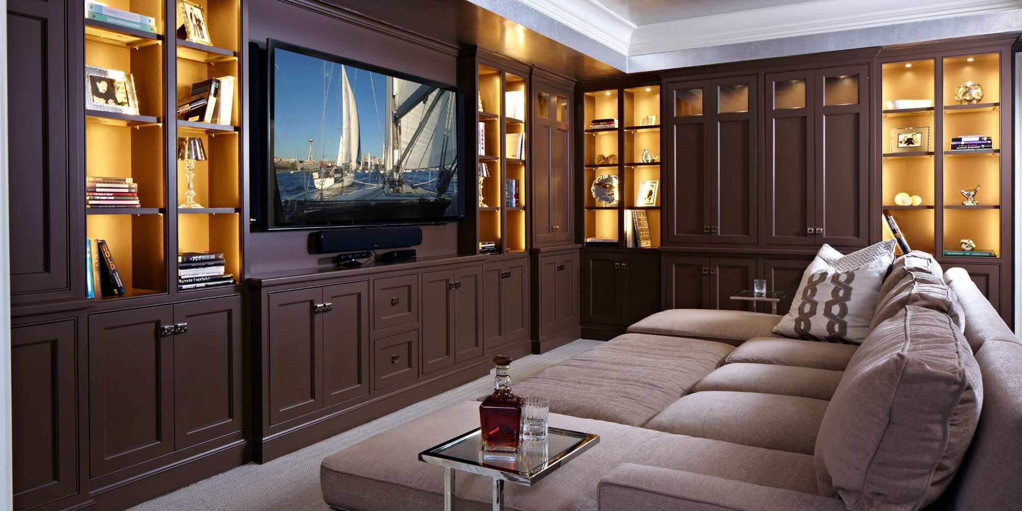 Cozy home addition with media wall and shelving by TR Design Build, New Canaan, CT