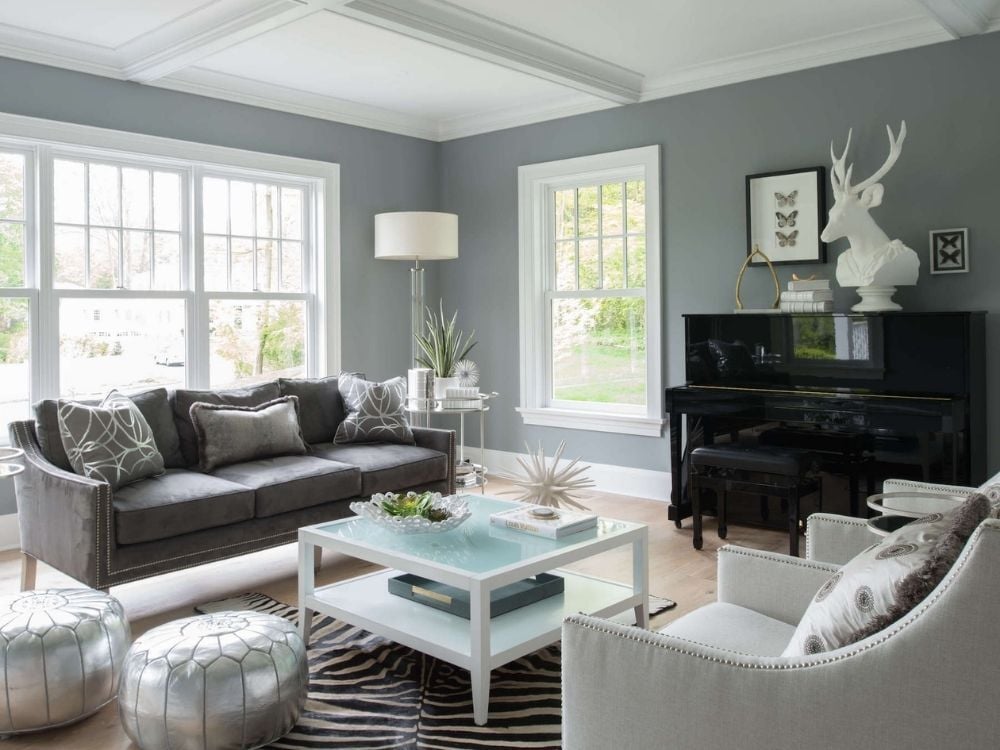A remodeled living room with large windows, gray walls, and white trim in Stamford, CT by TR Design-Build
