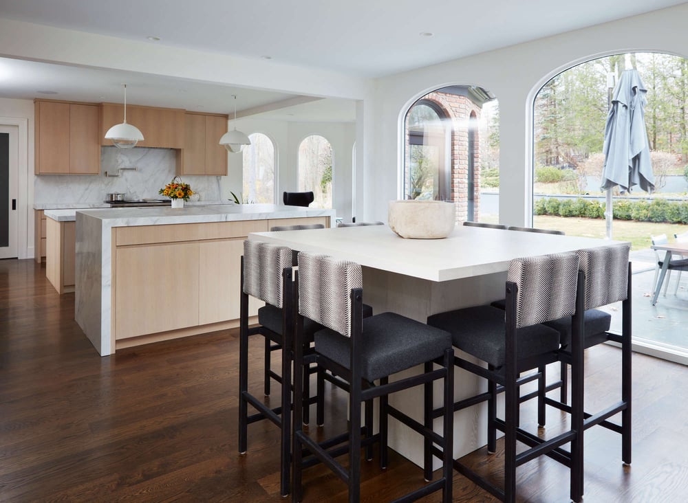 A New Canaan kitchen remodel with outdoor access and floor-to-ceiling windows overlooking a patio by TR Design-Build