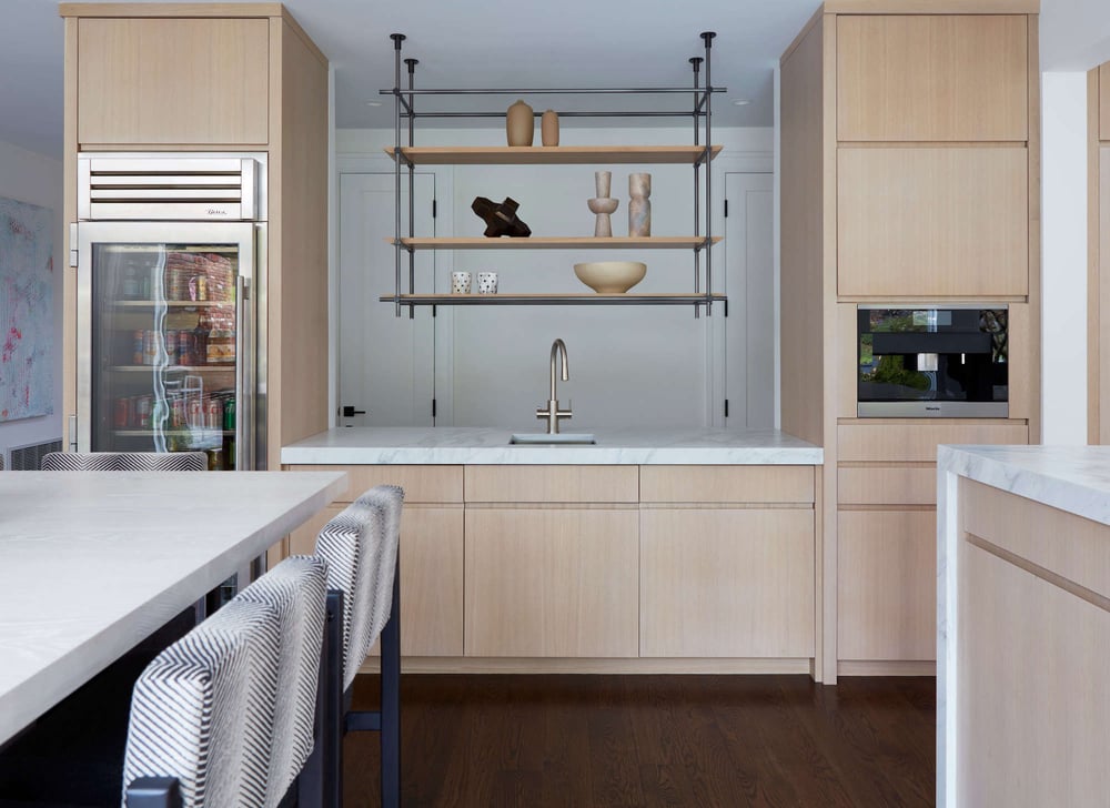 A remodeled kitchen with a beverage refrigerator and built-in coffee maker by TR Design-Build