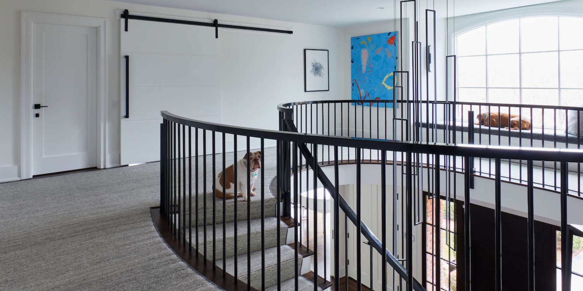 Image of a remodeled stairwell, rustic sliding door, and bench window seat by TR Design Build in New Canaan, CT