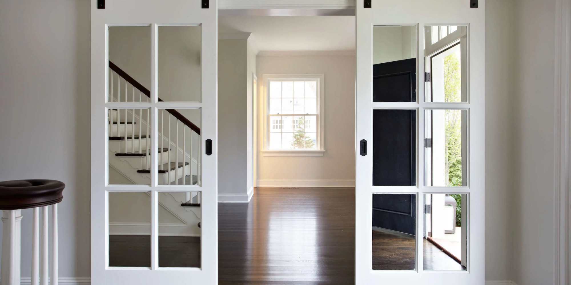 Rustic-style sliding doors with glass panes in a whole home renovation by TR Design Build