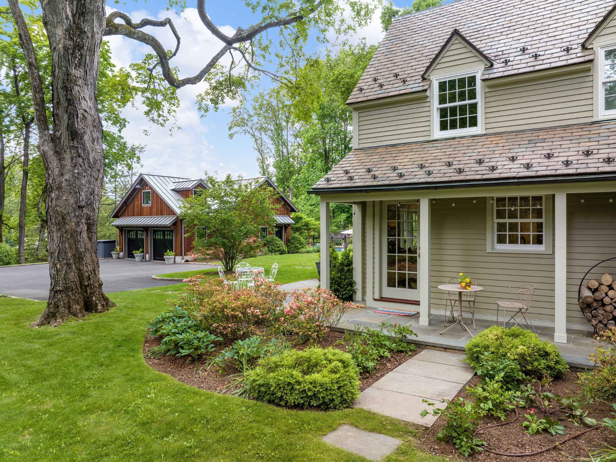 Exterior of a whole home remodel with a new portico and barn-inspired detached garage in New Canaan, CT by TR Design-Build Exterior of a whole home remodel with a new portico and barn-inspired detached garage in New Canaan, CT by TR Design-Build
